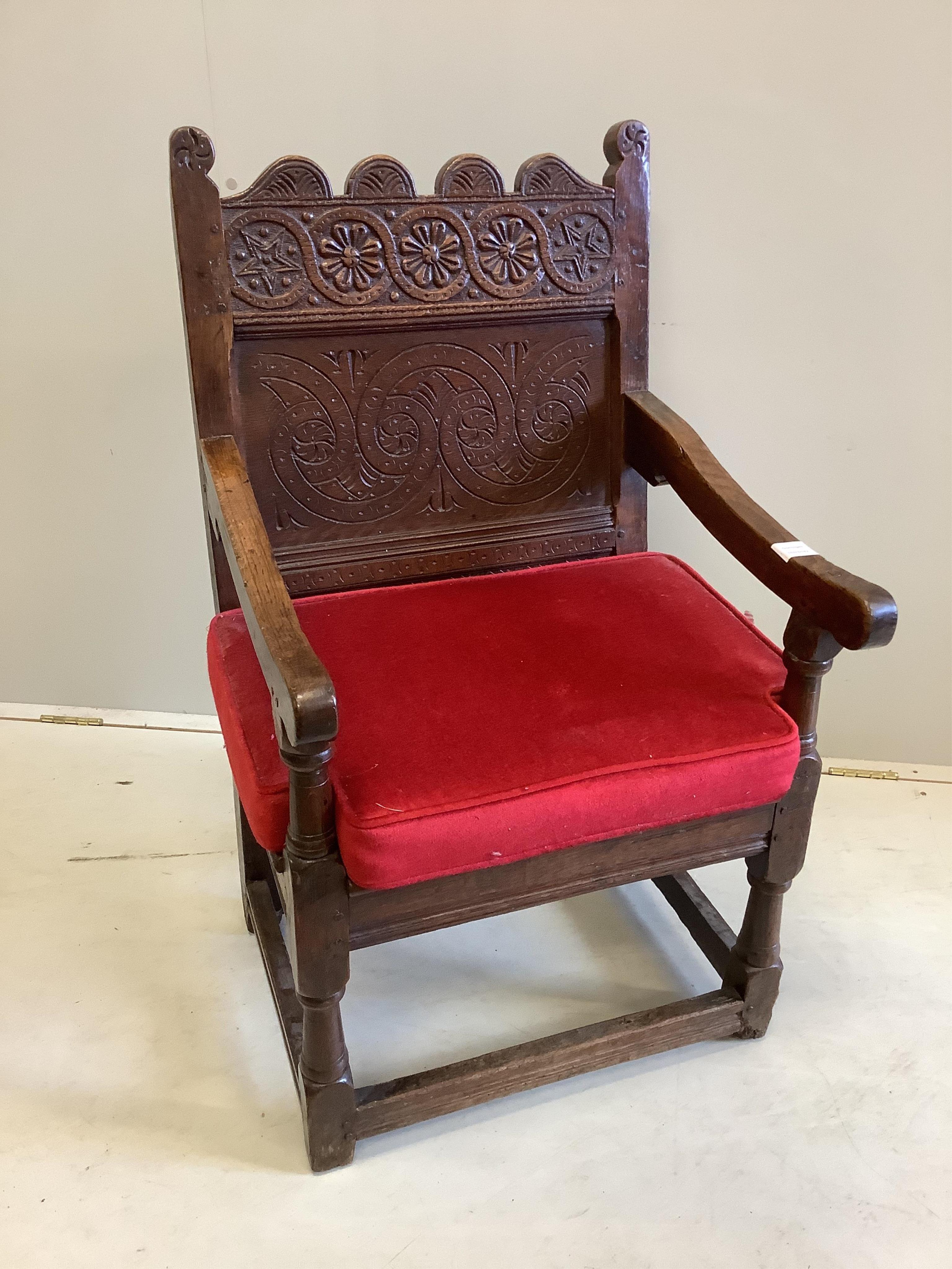 A 17th century carved oak wainscot elbow chair, width 57cm, depth 56cm, height 98cm. Condition - good